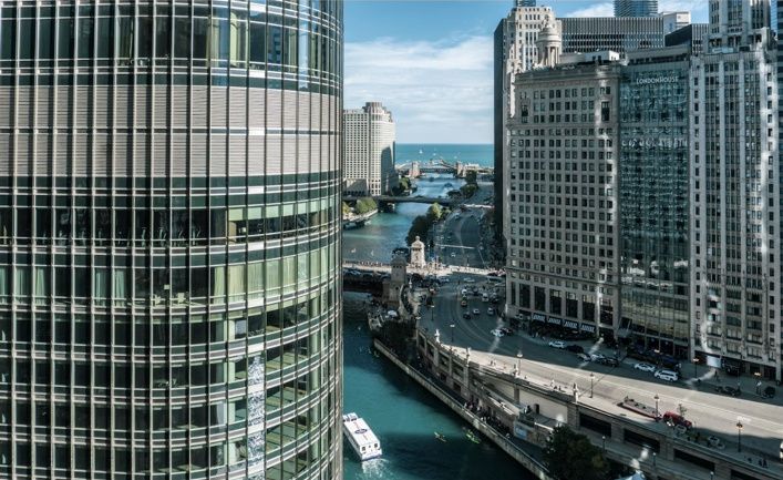 Chicago River between downtown high-rises, with bridges and the Riverwalk